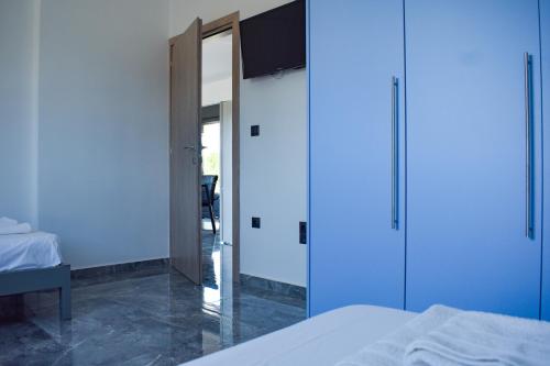 a bedroom with a large mirror and a bed at Alexandra's Place in Galatás