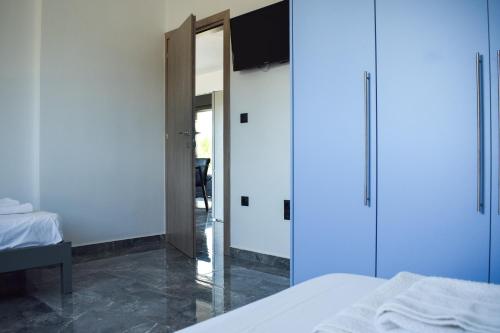 a bedroom with a bed and a sliding glass door at Alexandra's Place in Galatás