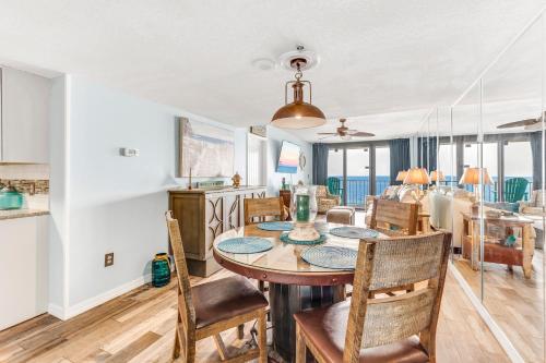 a dining room and kitchen with a table and chairs at Phoenix II 2042 in Orange Beach