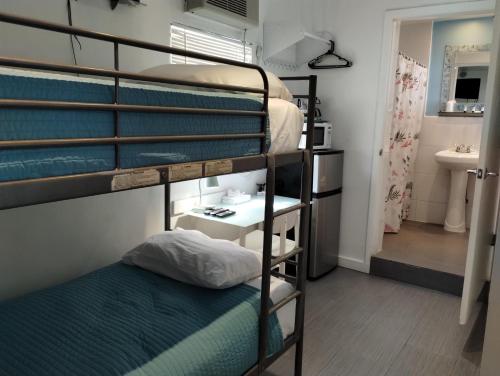 a room with three bunk beds and a bathroom at Snooze in Fort Lauderdale