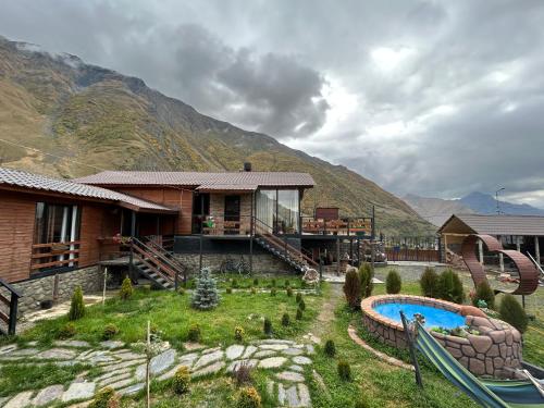 a resort with a slide and a playground at Panorama Cottages in Stepantsminda