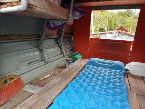 a table in the back of a rv with a window at The BoatBnB in Kampong Pandan