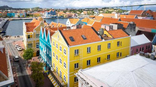an overhead view of a city with yellow buildings at La Casa Amarilla Apartments in Willemstad