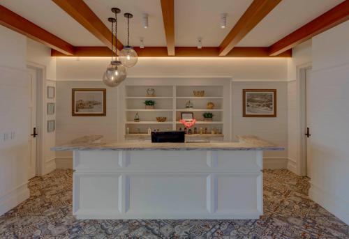 a large kitchen with a white island in a room at The Historic Cavalier Hotel and Beach Club Autograph Collection in Virginia Beach