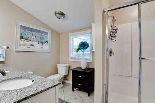 a bathroom with a toilet and a sink and a shower at Venice Island Private Pool Home Wows! Beach! Po in Venice