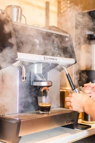 a person is making a drink in a coffee machine at Margaritaville Hotel San Diego Gaslamp Quarter in San Diego