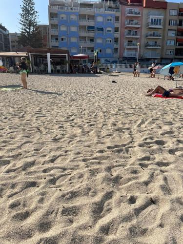 a group of people on a sandy beach at Palacio del mar in Torrevieja