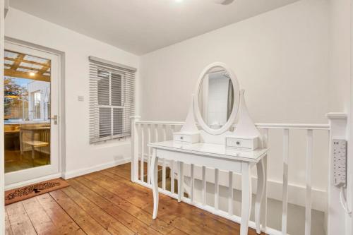 a white dressing table with a mirror on it at Apartment in Shoreditch/ Old St in London