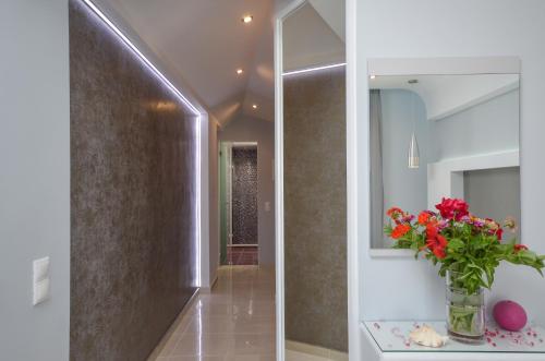 a hallway with a vase of flowers on a table at Villa Christine in Agia Anna Naxos