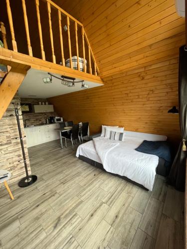 a bedroom with a bed and a wooden ceiling at Căsuțele de sub pădure in Avrig