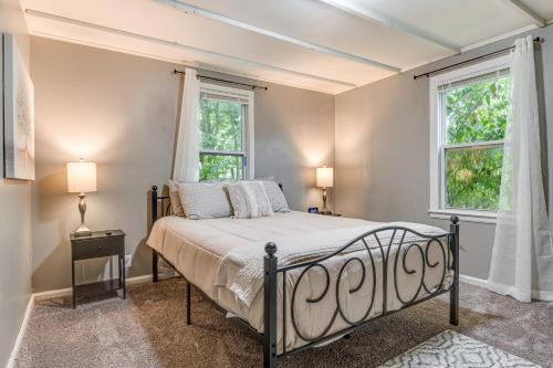 a bedroom with a bed and two windows at Charming Indianapolis Home about 9 Mi to Downtown! in Indianapolis