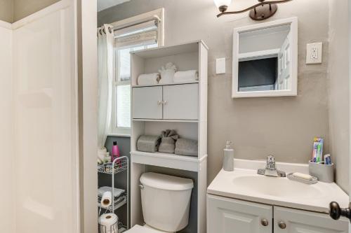 a small bathroom with a toilet and a sink at Charming Indianapolis Home about 9 Mi to Downtown! in Indianapolis