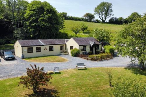 an aerial view of a house with a parking lot at Cowslip Cottage Serenity with Jacuzzi in Saundersfoot