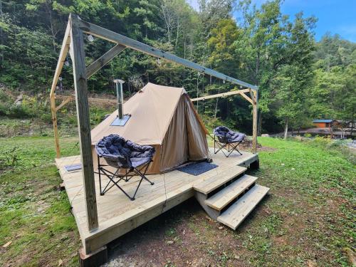 a tent and two chairs on a wooden deck at Glamping tent in Butler