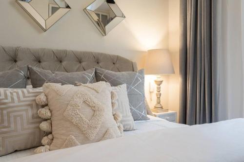 a bedroom with a white bed with pillows at Casa del Palmar, Elegant 3BR Home with Rooftop in Centro San Miguel in San Miguel de Allende