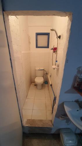 a small bathroom with a toilet and a sink at Riad Khira in Agadir