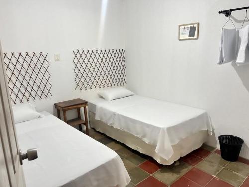 เตียงในห้องที่ Hostal Villa Marta