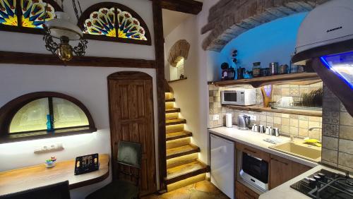 a kitchen with a sink and a stairway in a room at Medieval Super Studio in Vilnius