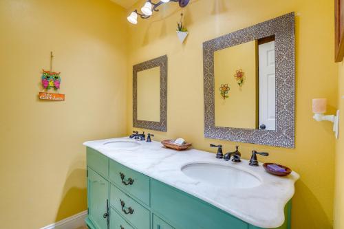 a bathroom with two sinks and two mirrors at Peaceful Haynesville Vacation Rental with Yard! 