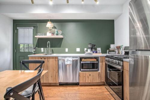 a kitchen with green walls and a wooden counter top at The Neighborhood Hotel Grand Beach in New Buffalo
