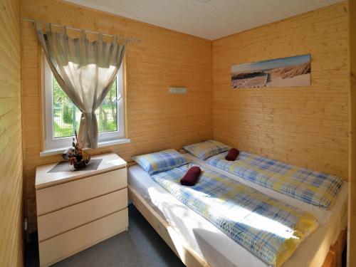 two twin beds in a room with a window at Meridia - Sventoji in Šventoji