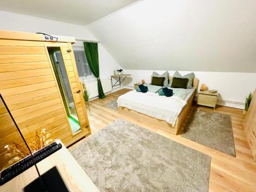 a bedroom with a bed and a large window at LeskóÉk Wellness & Home in Alsópáhok