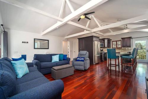 a living room with blue couches and a kitchen at Waterfront Captain House with Boat Basin & Ramp in Summerland Key