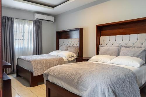 a hotel room with two beds and a window at Residencial Del Golf in La Lima