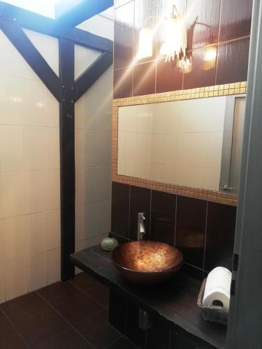 a bathroom with a wooden sink and a mirror at Guest House Factory in Malacky