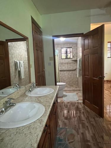 a bathroom with two sinks and a toilet at Castlevue B&B in Montego Bay