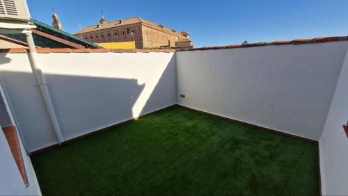 a balcony with green grass on a white wall at Casa Rural Teralba 2 in La Calzada de Oropesa