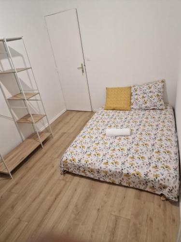 um pequeno quarto com uma cama e uma escada em Ian'Éliel Appart em Compiègne
