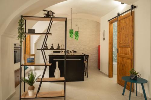 a room with a kitchen with a table and a shelf at Romantic Suite in Gallipoli