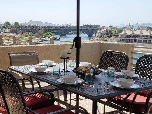 a black table and chairs with a view of a bridge at Its A Kings View in Lake Havasu City