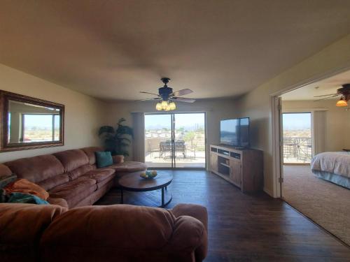 a living room with a couch and a television at Its A Kings View in Lake Havasu City