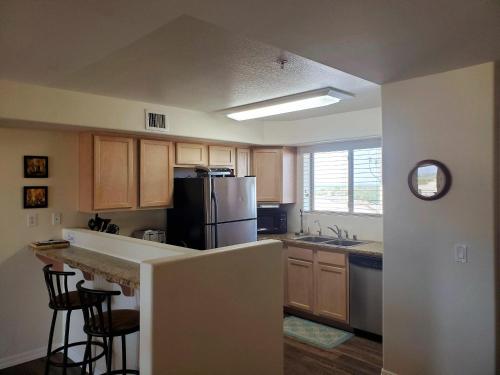 a kitchen with a refrigerator and a counter top at Its A Kings View in Lake Havasu City