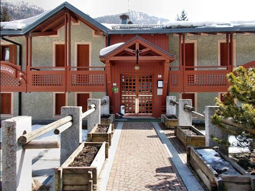 a building with a pathway leading to the front door at Residence Orsa Maggiore in Madonna di Campiglio