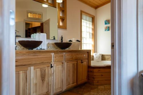 a bathroom with two sinks on a wooden counter at Homer Inn & Spa in Homer