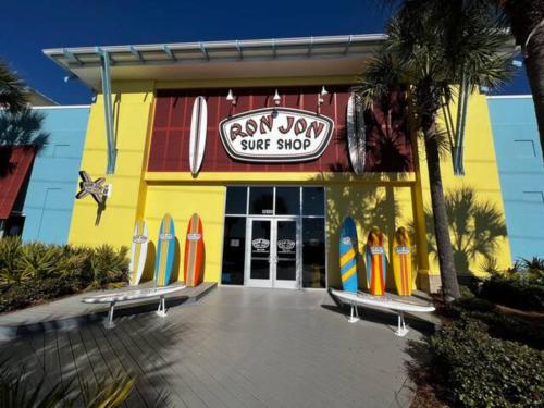 a surf shop with surfboards parked outside of it at The Coastal Cabana in Panama City Beach