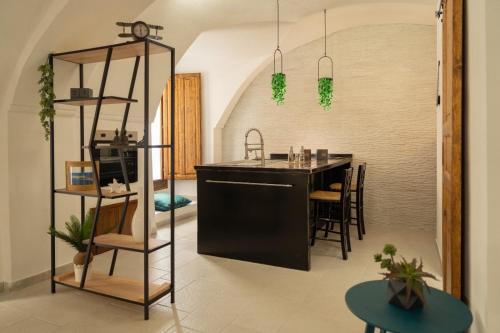 a kitchen with a black island in a room at Romantic Suite in Gallipoli