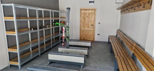 a row of benches in a room with a door at AURORA Bela reka C117, Brzeće in Brzeće
