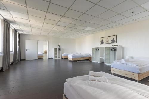 a large room with three beds in it at T&K Apartments 6 and 10 Room Apartment in Neuss for big Groups 22min to Fair DUS in Neuss