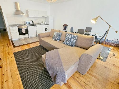 a living room with a couch and a kitchen at Stay at Home in Lisbon in Lisbon