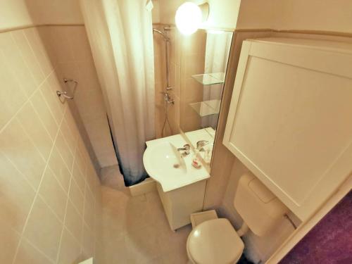 a small bathroom with a sink and a toilet at Cozy Studio Athenee in Bucharest