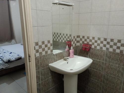 a bathroom with a sink and a shower at Kings Millennium in Nairobi