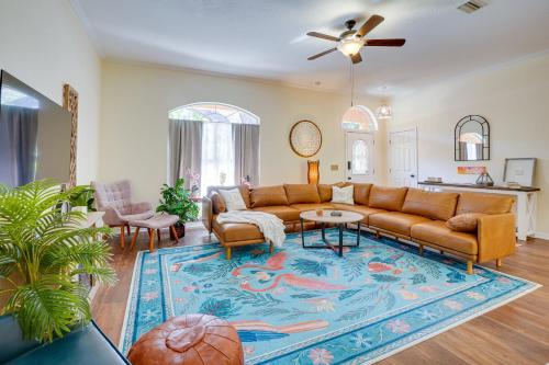 a living room with a couch and a rug at Tarpon Springs Family Getaway with Patio and Hot Tub! in Tarpon Springs