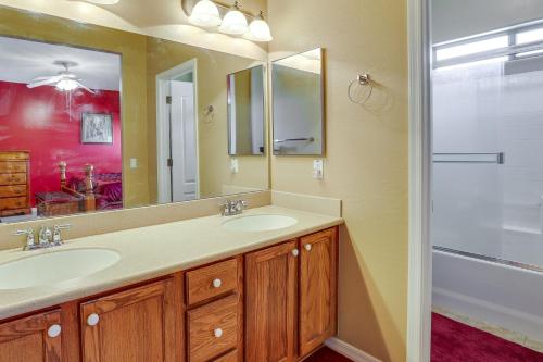 a bathroom with two sinks and a mirror and a shower at El Mirage Vacation Rental with Community Pool in El Mirage