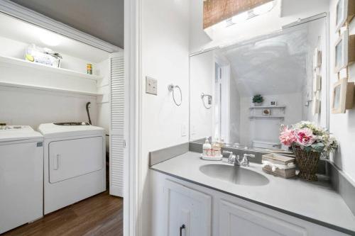 a white kitchen with a sink and a washing machine at Townhome - Convenient Location in Houston