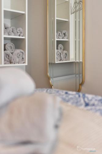 a room with a mirror and a shelf of towels at Luxury Apartment - Roe Getaway Limavady in Limavady