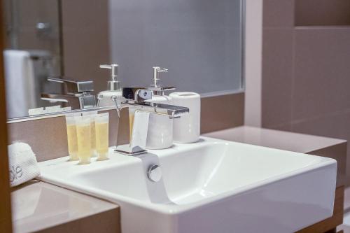 a white sink in a bathroom with a mirror at City Walk Chic living 1 Bedroom apartment in Dubai